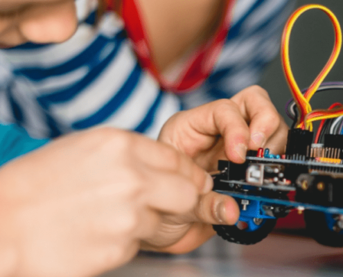 Child doing electrical repairs on a toy