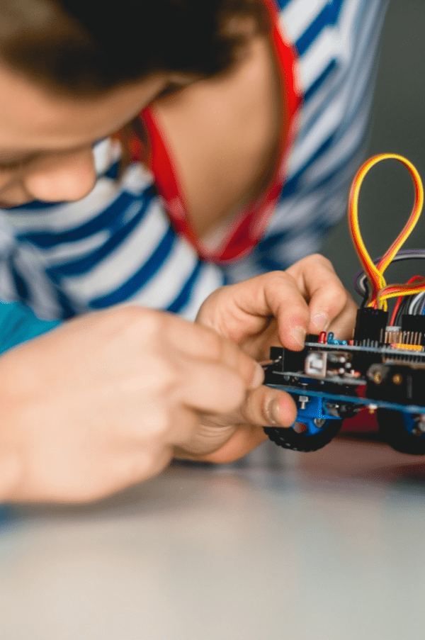 Child doing electrical repairs on a toy